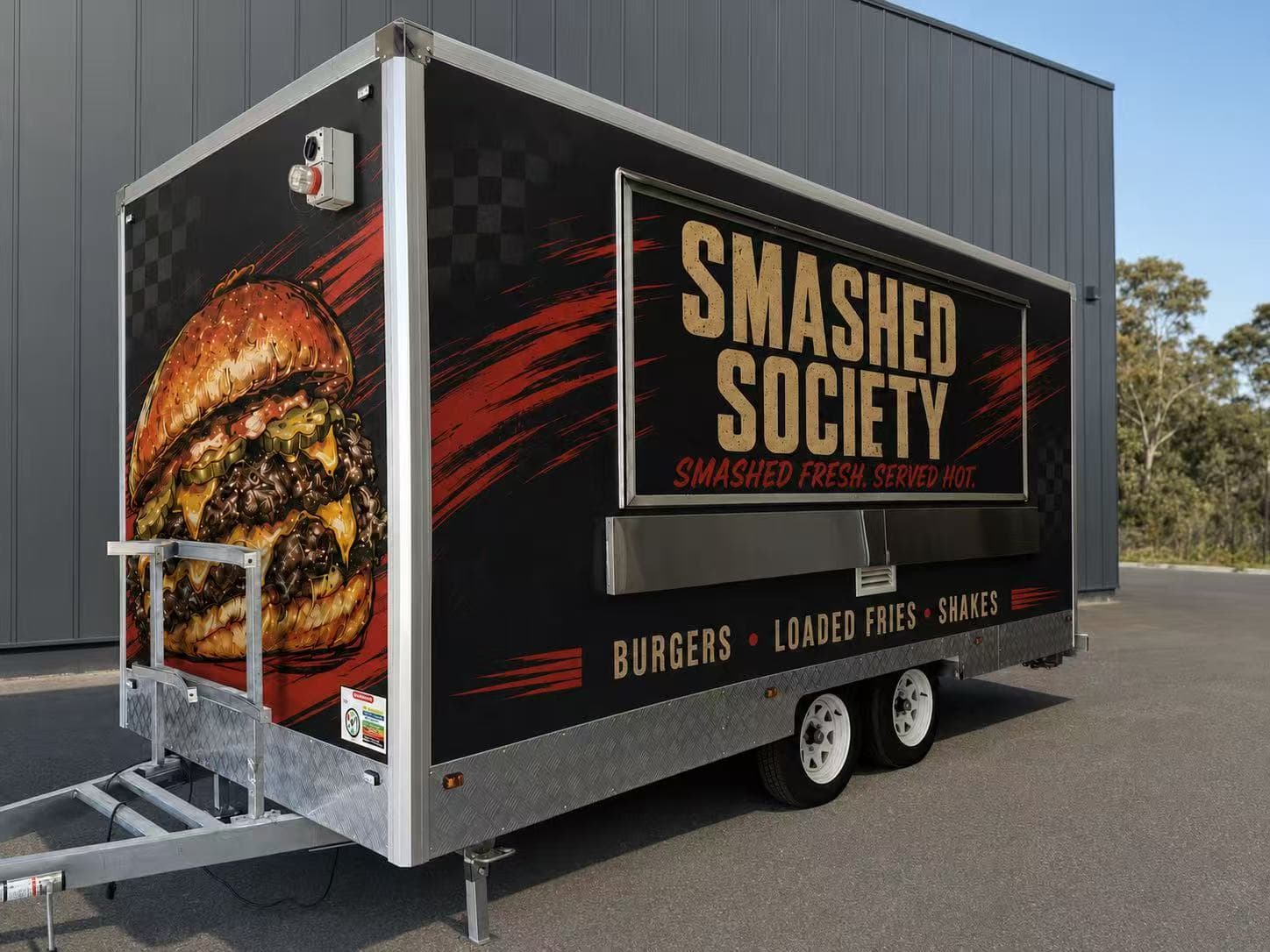 Black Smashed Society food trailer with a full burger-themed wrap